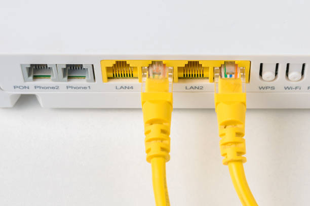 istock home wireless router with ethernet cables plugged in, closeup 1093655820