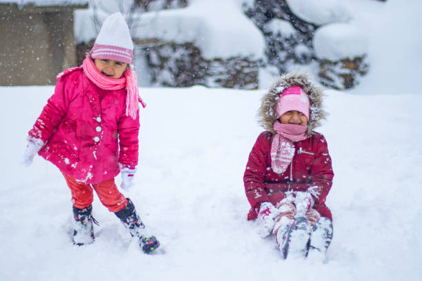 istock Cheerful kids having fun with snow in winter day 1093656416