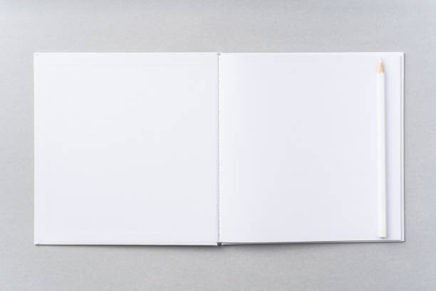 istock Top view of white hardcover notebook, pencil 1093656630
