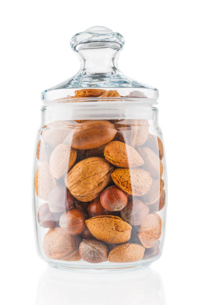 istock Different kind of nuts in glass jar on white background 1093658688