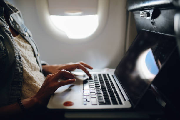 istock Young woman finishing her work in airplane 1093659766