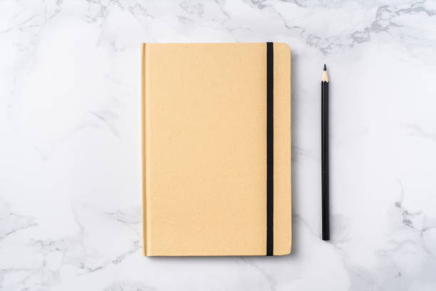 istock Top view of kraft paper notebook, pencil 1093661350