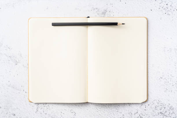 istock Top view of kraft paper notebook, page, pencil 1093661516