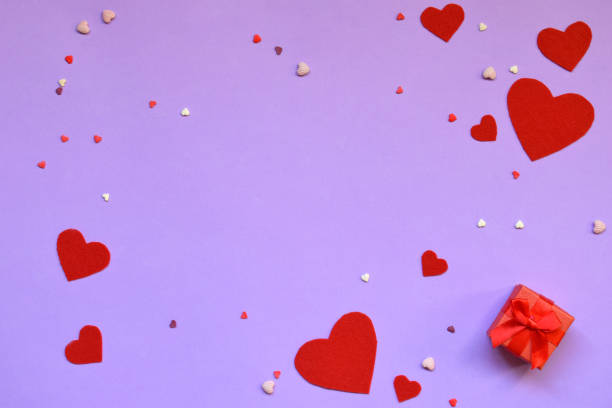 istock Red felt hearts and present box on pink background. Valentine's Day gift or greeting card concept. 1093662034