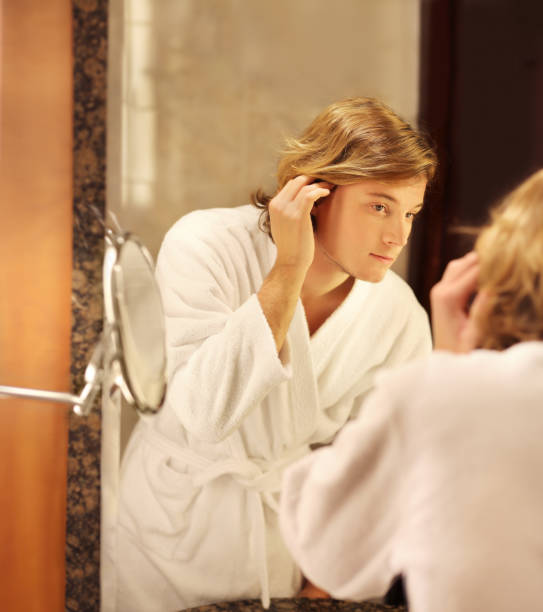 istock Applying the cream.young man looking in the mirror 1093669346