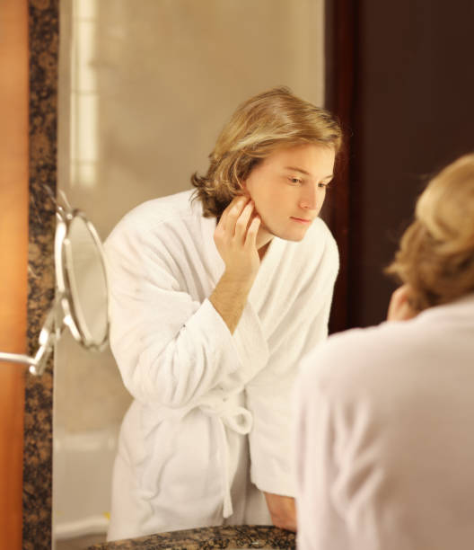 istock Applying the cream.young man looking in the mirror 1093669354