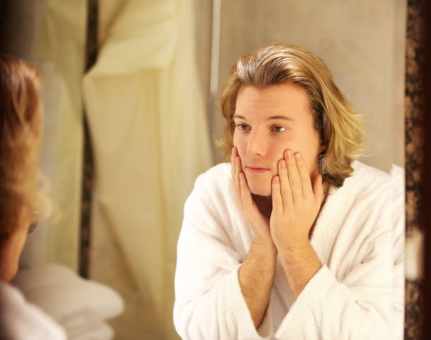 istock Applying the cream.young man looking in the mirror 1093669394