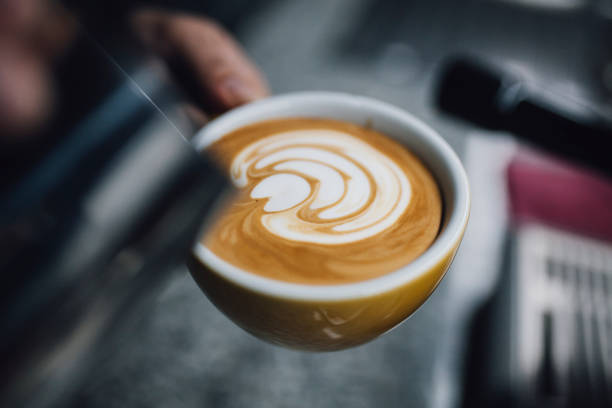 istock Barista holding coffee cup and make latte art coffee 1093672352