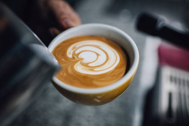 istock Barista holding coffee cup and make latte art coffee 1093672360