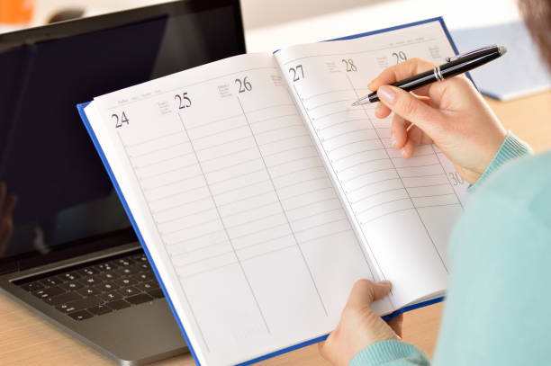 istock Businesswoman taking notes in agenda 1093672798