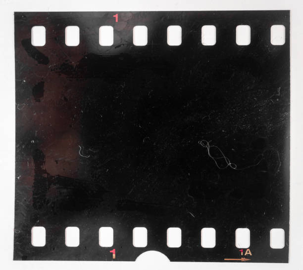 Real and original 35mm or 135 film material on white background, 35mm filmstrip real 35mm film material rolling photos stock pictures, royalty-free photos & images
