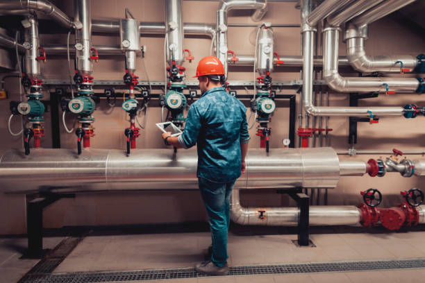 Stationary engineer at work Stationary engineer at work water pipe stock pictures, royalty-free photos & images