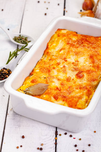 istock Potato gratin in white casserole dish on wooden rustic table. Close up 1093678968