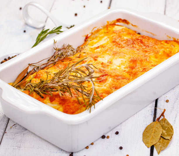 istock Potato gratin in white casserole dish on wooden rustic table. Close up 1093679010