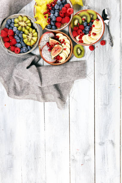 istock fruit bowl. Bowl of healthy fresh fruit salad on rustic background 1093683054