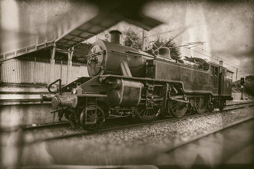 Old steam train, vintage locomotive on train station  - retro photography