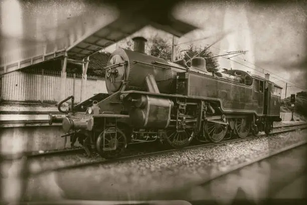 Photo of Old steam train, vintage locomotive on train station  - retro photography