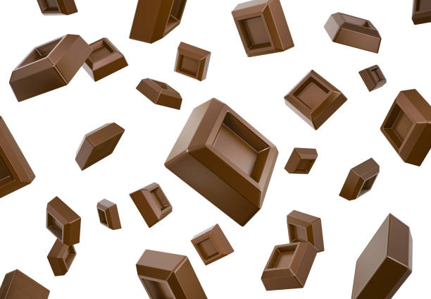 Many chocolate cubes falling down flying in white space. Isolated. stock photo