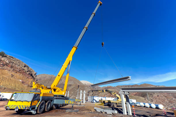 istock The big crane is lifting a concrete block for pipe bridge in the construction site. 1093688858