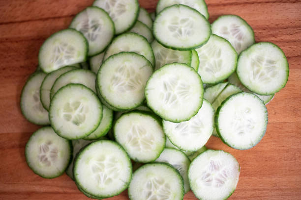 istock Cucumber slices on wooden board 1093691166