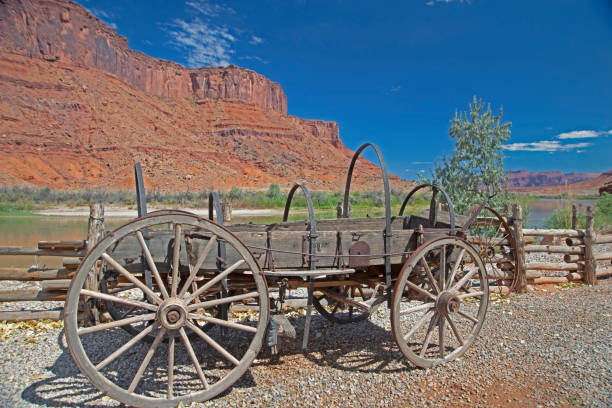 istock An old wooden wagon sits beneath towering red rock mountains. 1093691196