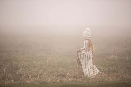 Caucasian Young Child Running, Dancing, Twirling in the Beautiful Dreamlike Fog