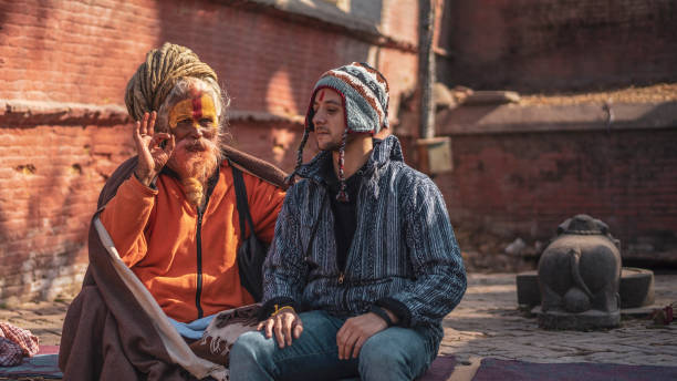 Man in hat sitting with clergy in temple