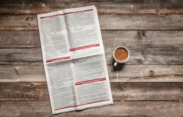 istock Reading newspaper on wooden background 1093702016