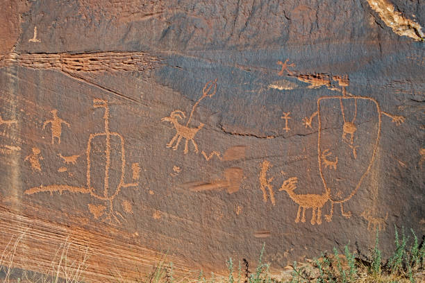 istock A rock wall is carved with rock art symbols. 1093706118