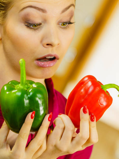 istock Woman holding bell peppers paprika thinking 1093707740