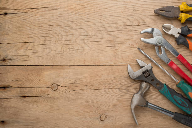 istock Working tools on a wooden rustic background. Top view with an empty place for inscription or advertising 1093713692