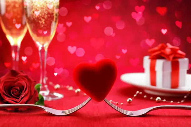 - Forks And Heart With Defocused Gift And Champagne -
