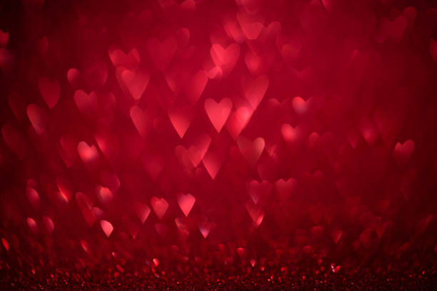 istock Red shiny glitter holiday beautiful background with bokeh shape hearts. Studio shot 1093722792