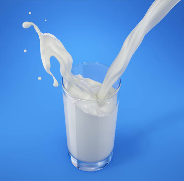 istock Pouring milk in glass with splash. Viewed from above. Isolated On blue. 1093724646
