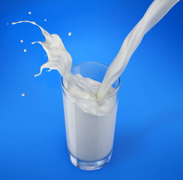 istock Pouring milk in glass with splash. Viewed from above. Isolated On blue background. 1093724648