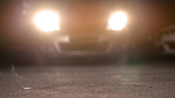 istock Cigarette butt on road in front of car, littering and environmental problems 1093725612