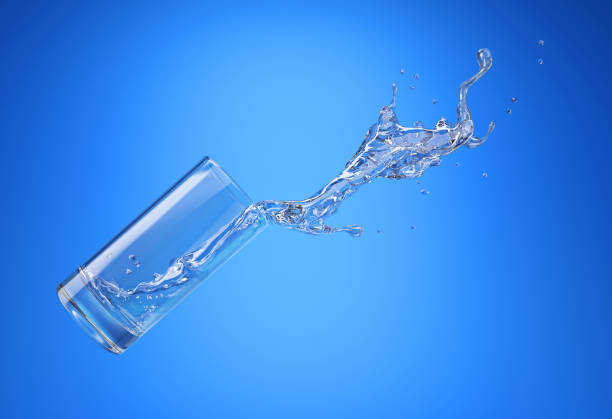 istock Glass with spilling water splash. Side view. On blue background. 1093730682