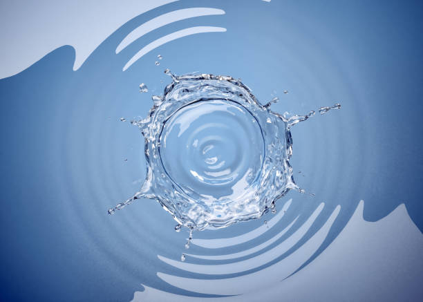Water crown splash in a water pool, with circular ripples around. stock photo