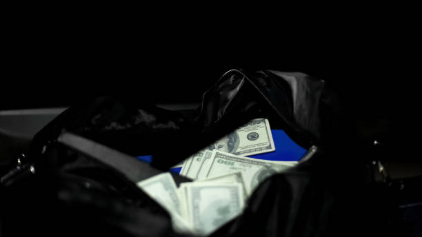 istock Bag with stolen from bank money and valuable documents lying on dark background 1093733878