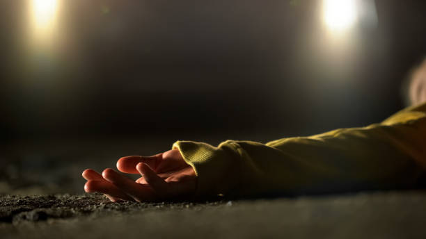 Bloody female victim of deadly car accident lying on road, close-up view at body Bloody female victim of deadly car accident lying on road, close-up view at body murderer stock pictures, royalty-free photos & images