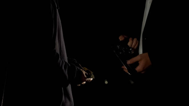istock Anonymous client ordering kill to contract killer in suit near car at night 1093734092