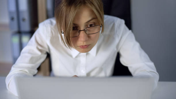 istock Overworked girl staring at computer screen, eyes wide open, working hard 1093734488