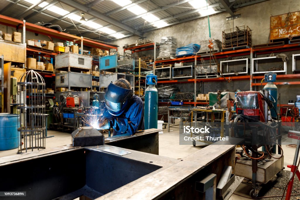 Female Welder Young Female Welder Working In Factory Wearing Protective Safety Gear Welder Stock Photo