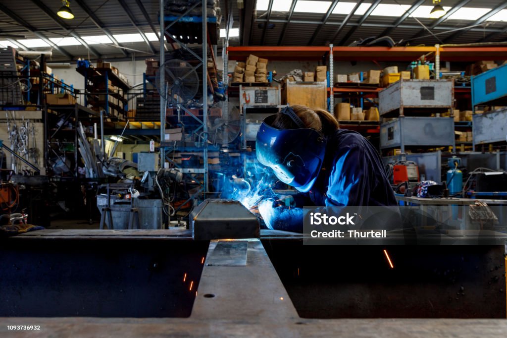 Female Welder Young Female Welder Working In Factory Wearing Protective Safety Gear Welder Stock Photo