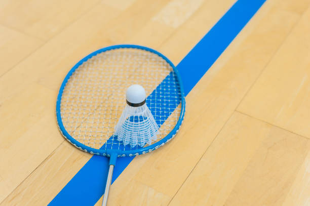 istock White badminton shuttlecock on a hall floor at badminton courts .Close up shuttlecocks on racket badminton at badminton courts. 1093740428