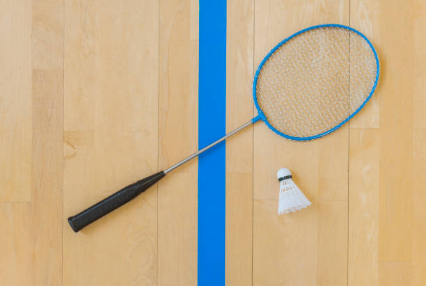 istock White badminton shuttlecock on a hall floor at badminton courts .Close up shuttlecocks on racket badminton at badminton courts. 1093740436