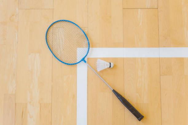 istock White badminton shuttlecock on a hall floor at badminton courts .Close up shuttlecocks on racket badminton at badminton courts. 1093740438