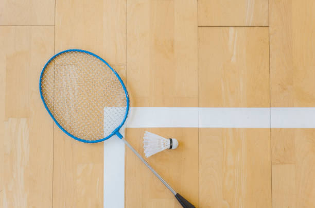 istock White badminton shuttlecock on a hall floor at badminton courts .Close up shuttlecocks on racket badminton at badminton courts. 1093740444