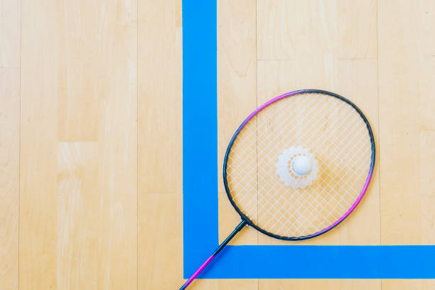 istock White badminton shuttlecock on a hall floor at badminton courts .Close up shuttlecocks on racket badminton at badminton courts. 1093740446