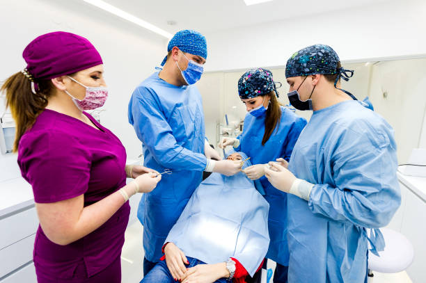 istock Group of Young Dentists Working on Patient in Dentist Office 1093741020